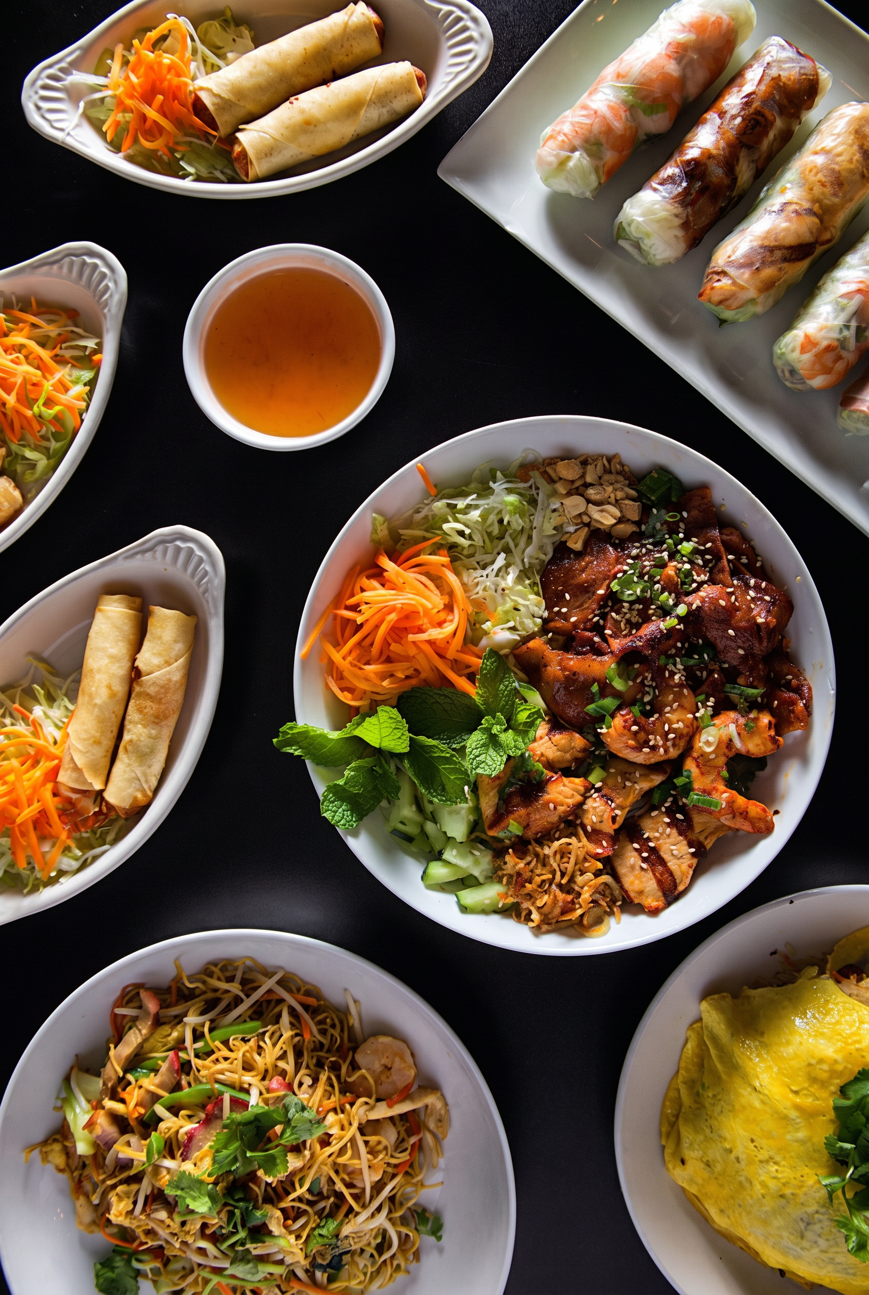 Houston food photographer overhead spread of Vietnamese dishes with grilled pork, spring rolls and noodles